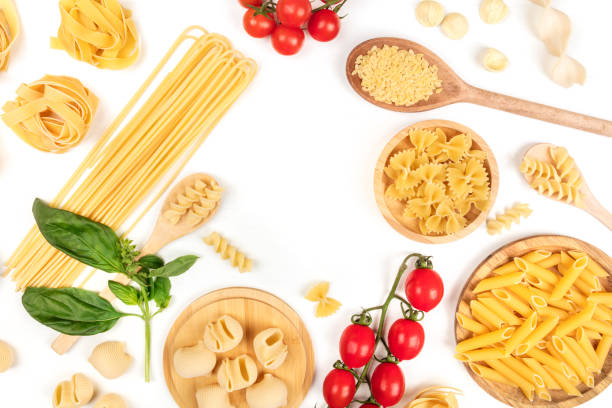 istock Overhead photo of different types of pasta on white, forming frame 916077158