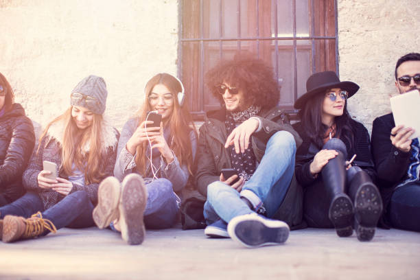 istock Young people sitting on floor enjoying their free time 916080026