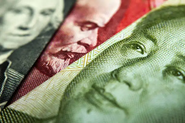 Close-up of an Chinese yuan, a Russian Ruble and an American dollar banknote