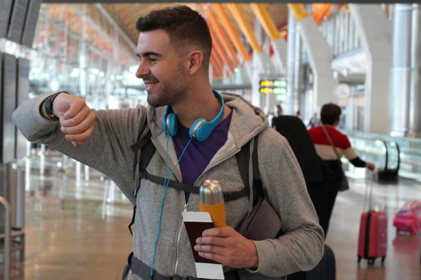 istock Relaxed male checking the time at airport 916085002
