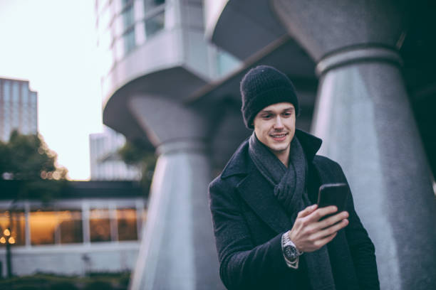 istock Man on the street texting 916091002