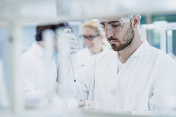 istock Scientist Pipetting into Test Tube 916091500