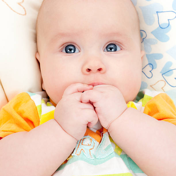 istock Infant with hands in mouth 91609223