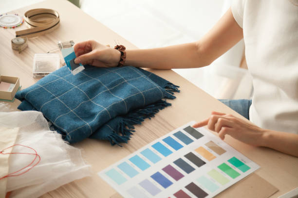 Female fashion designer holding samples choosing color working w