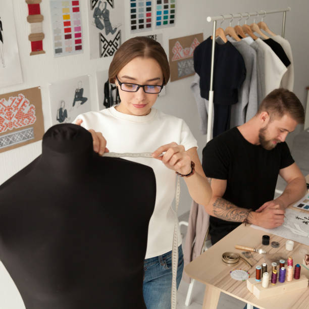 istock Creative fashion designers team working in clothes design studio 916092436