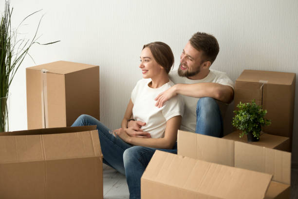 istock Young couple embracing looking forward to future in new home 916092538