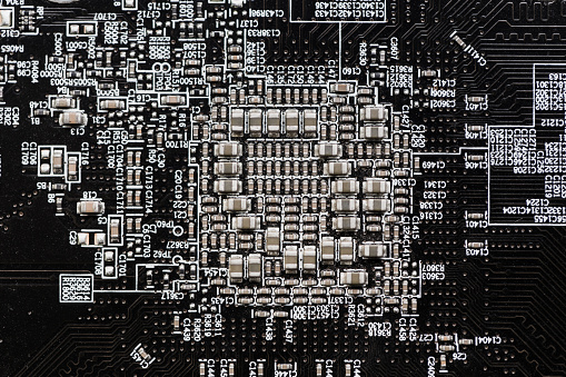 Ceramic Capacitors at Digital electronic circuit board closeup very small type