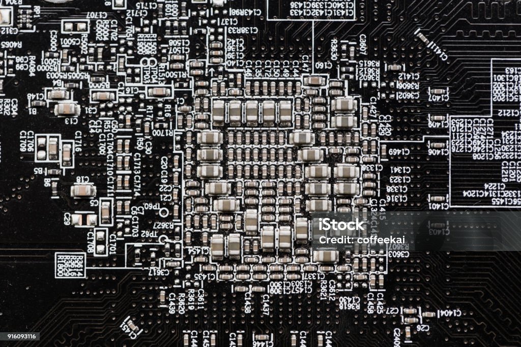 Ceramic Capacitors at Digital electronic circuit board closeup very small type Capacitor Stock Photo