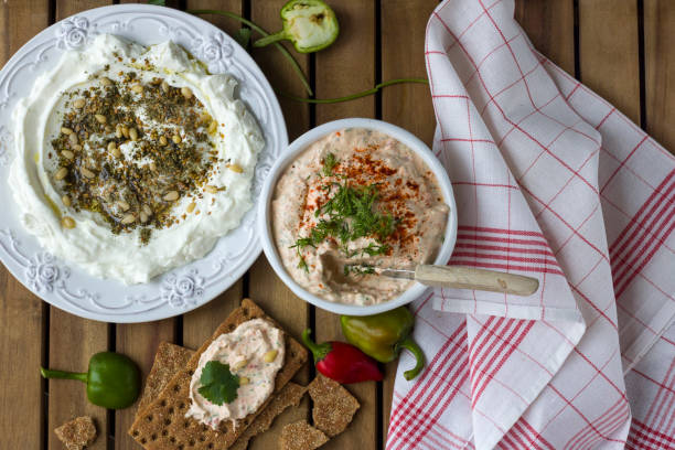 istock Middle Eastern dish - dense homemade labneh yoghurt with zatar in white dishes. Daylight. 916093898