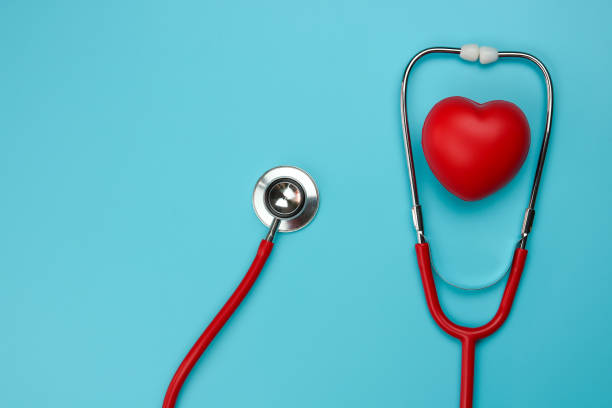 istock stechoscope on  blue background with red heart 916098166