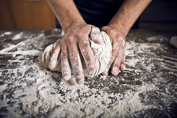 Male hands kneading bread stock photo