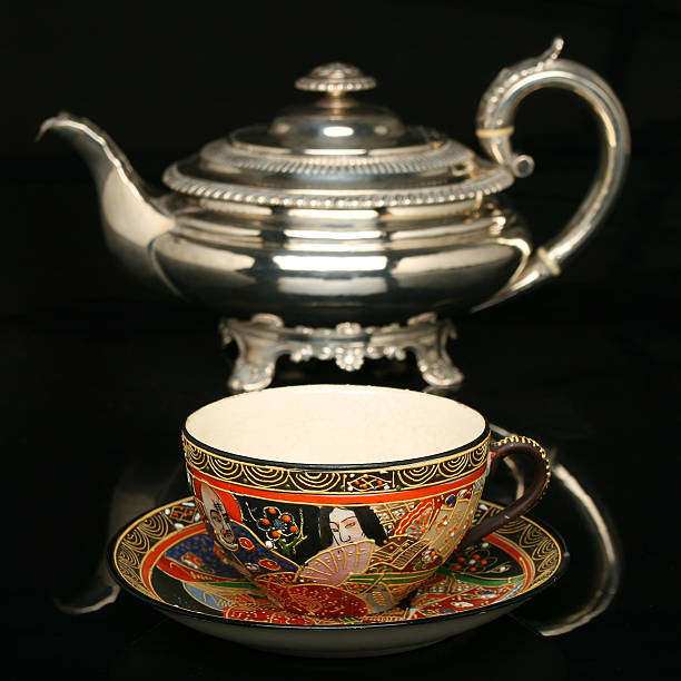 istock Silver teapot and an antique chinese cup of tea 91610540