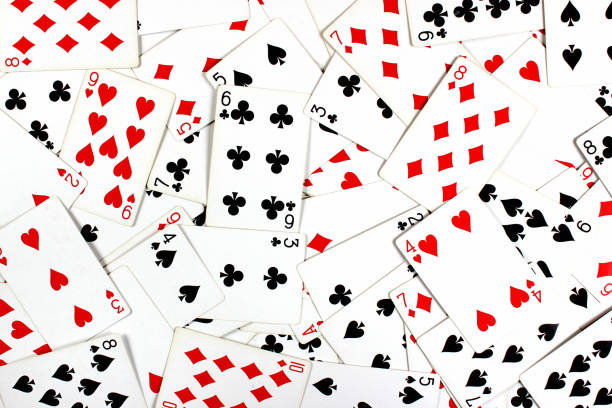 istock Red and black playing cards as background 916115616