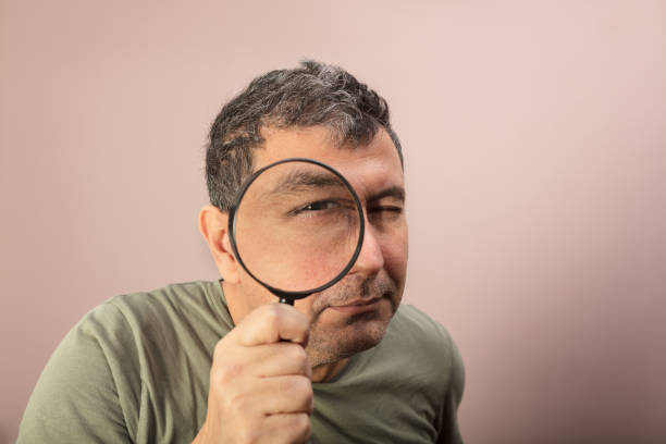 istock Man searching for clues with a magnifying glass 916115922