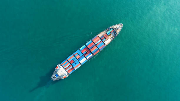 istock Container ship in export and import business and logistics. Shipping cargo to harbor by crane. Water transport International. Aerial view 916117146