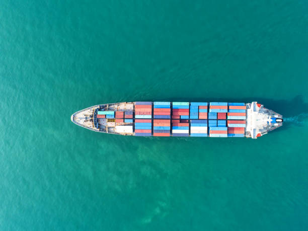 istock Container ship in export and import business and logistics. Shipping cargo to harbor by crane. Water transport International. Aerial view 916117156