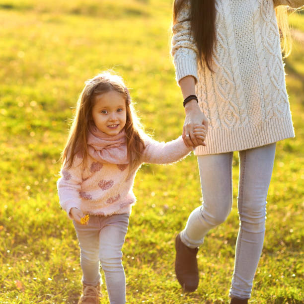 istock daughter at sunset playing with mom 916120416