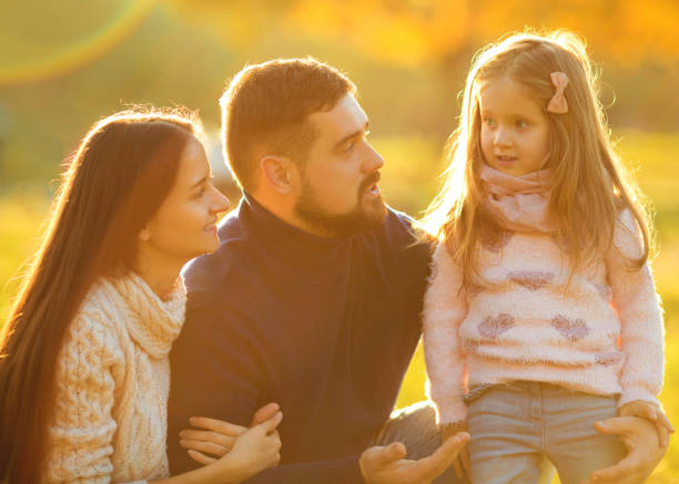 istock Family playing in autumn park having fun at sunset 916120466