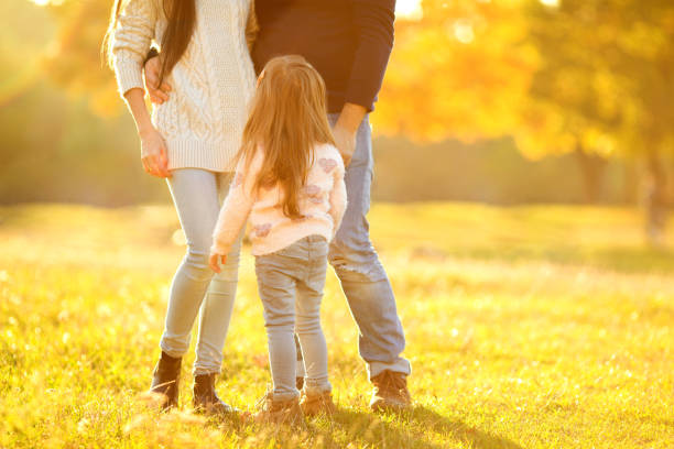 istock Family playing in autumn park having fun 916120550