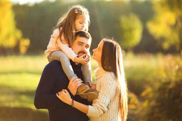 istock Family playing in autumn park having fun at sunset 916120652