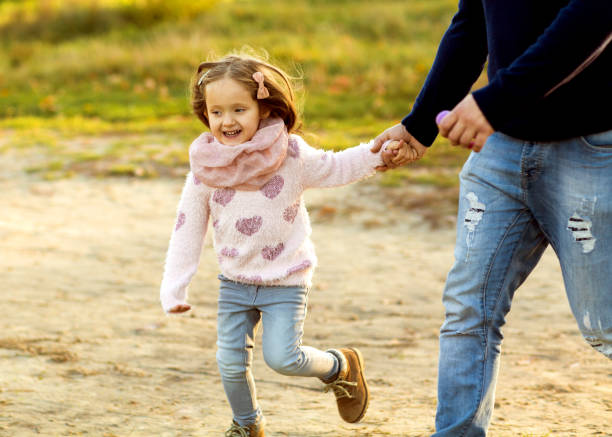 istock daughter at sunset playing with mom 916121144