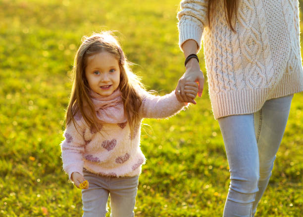 istock daughter at sunset playing with mom 916121226