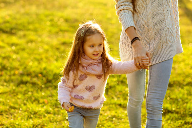 istock daughter at sunset playing with mom 916121228