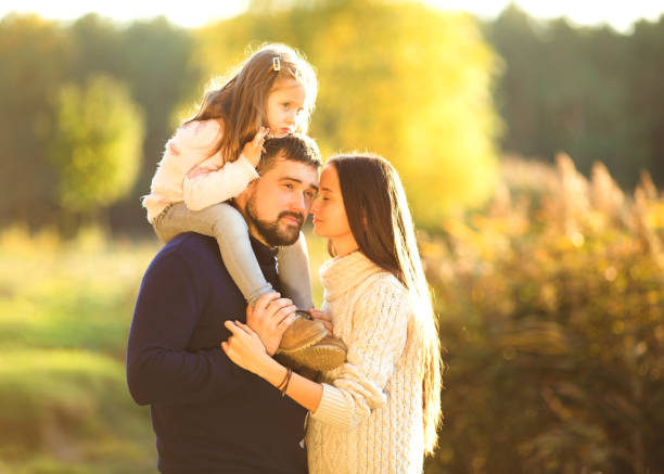 istock Family playing in autumn park having fun 916121318