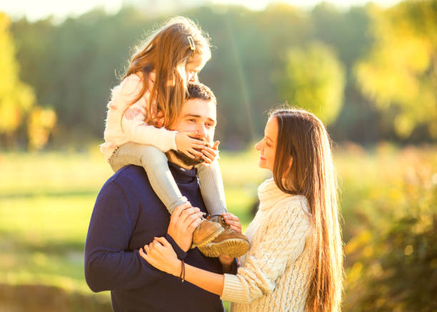 istock Family playing in autumn park having fun 916121328