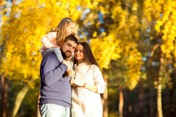 istock Family playing in autumn park having fun at sunset 916121448