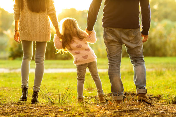 istock Family playing in autumn park having fun at sunset 916121490