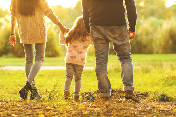 istock Family playing in autumn park having fun at sunset 916121504