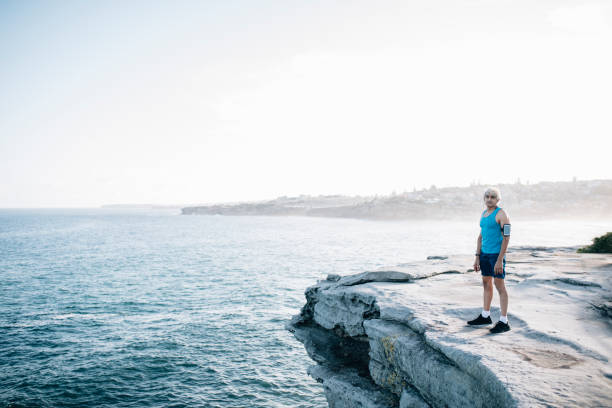 istock Gray hair senior runner looking at the ocean 916121892