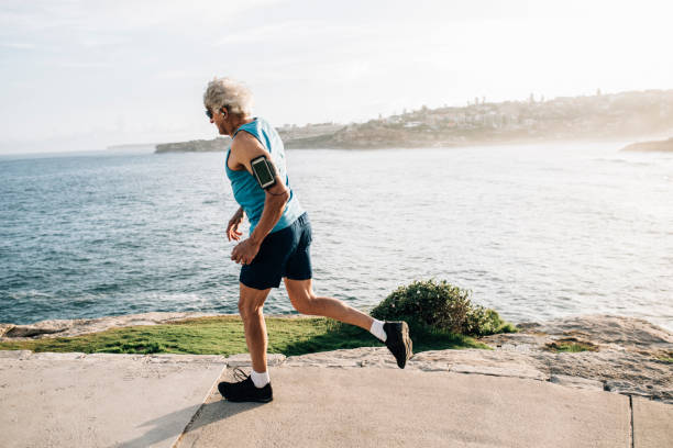 istock Active senior man runs near ocean 916122394