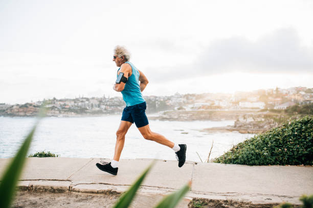 istock Senior man warms up for run 916122566