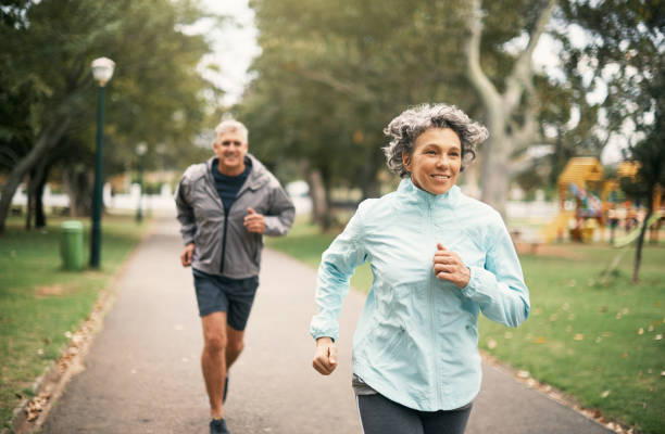 Fitness is an important part of their marriage Shot of a senior couple out for a run in the park cardiovascular exercise stock pictures, royalty-free photos & images