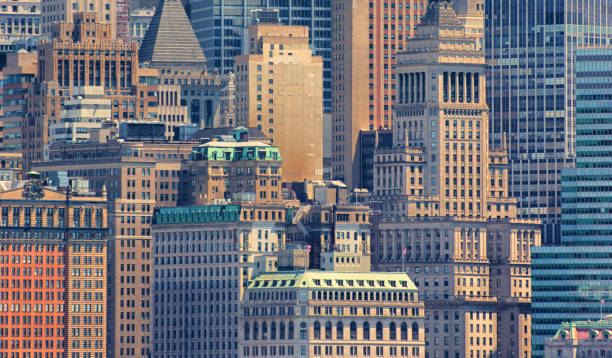 Close up of buildings in Wall Street Close up of buildings in Wall Street showing the various sizes and shapes of skyscrapers. wall street lower manhattan photos stock pictures, royalty-free photos & images