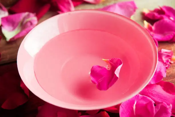 rose water - flower petals rose, towel, concept of care and beauty treatments in Spa