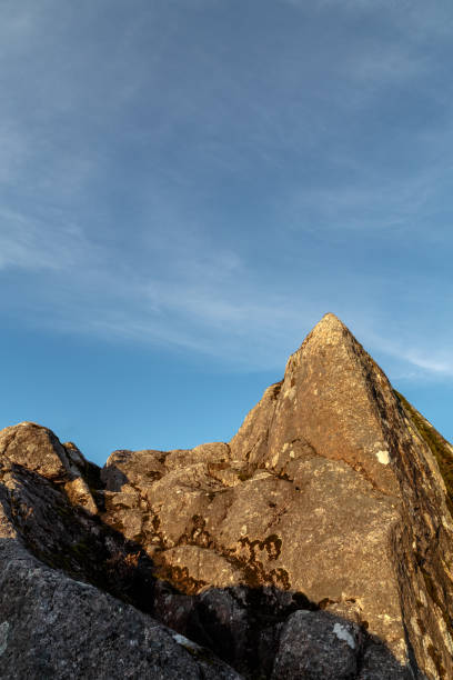 istock Sun hitting a cliff with blue sky as background 916134704
