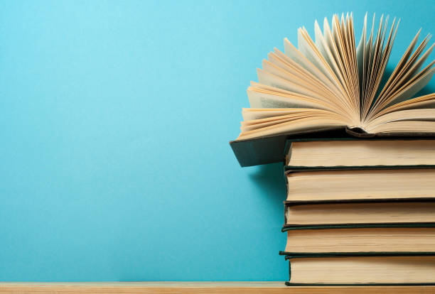 istock Open book on stack of books on wooden table. Education background. Back to school. Free copy space. 916135370