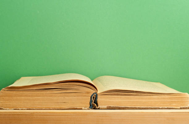 istock Old open book on wooden table. Education background. Back to school. 916135618