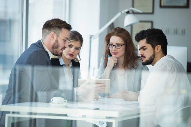 istock Group of business people collaborating in office 916141804