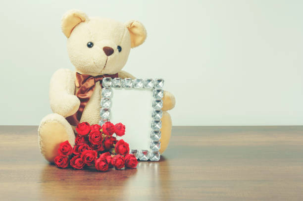istock Valentine's day concept : Teddy bear hugging diamond frame and roses 916149636