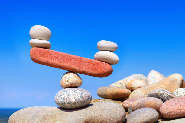 symbolic scales from stones. the disturbed equilibrium. imbalance concept. - balance simplicity nature beach imagens e fotografias de stock
