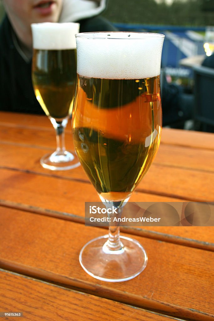 Two beer glasses (model pilsner / tulip) on beer garden table  Addiction Stock Photo