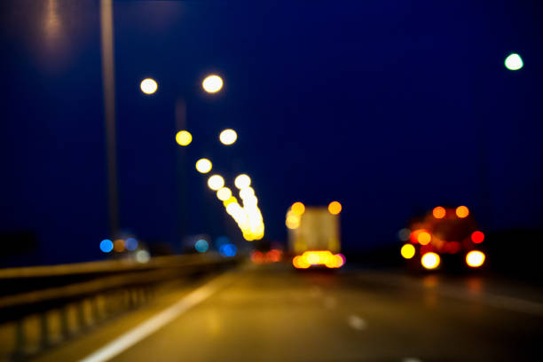 istock View through the windshield of a car on blurred ahead moving trucks. 916159702