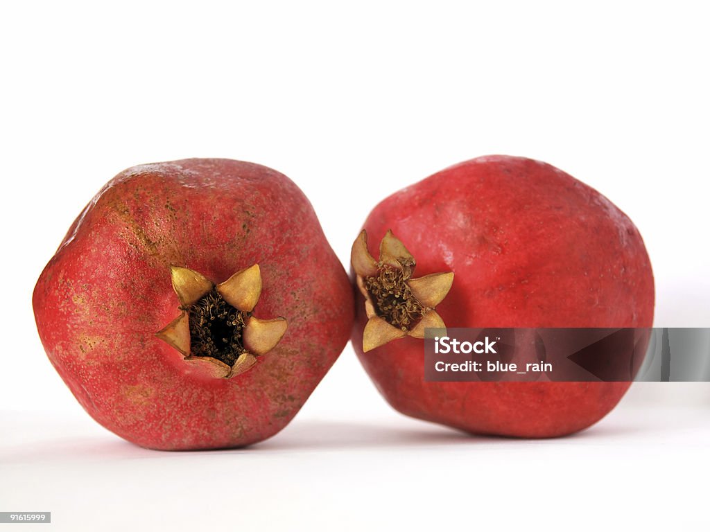 Two pomegranates Red juicy pomegranates on white background Antioxidant Stock Photo