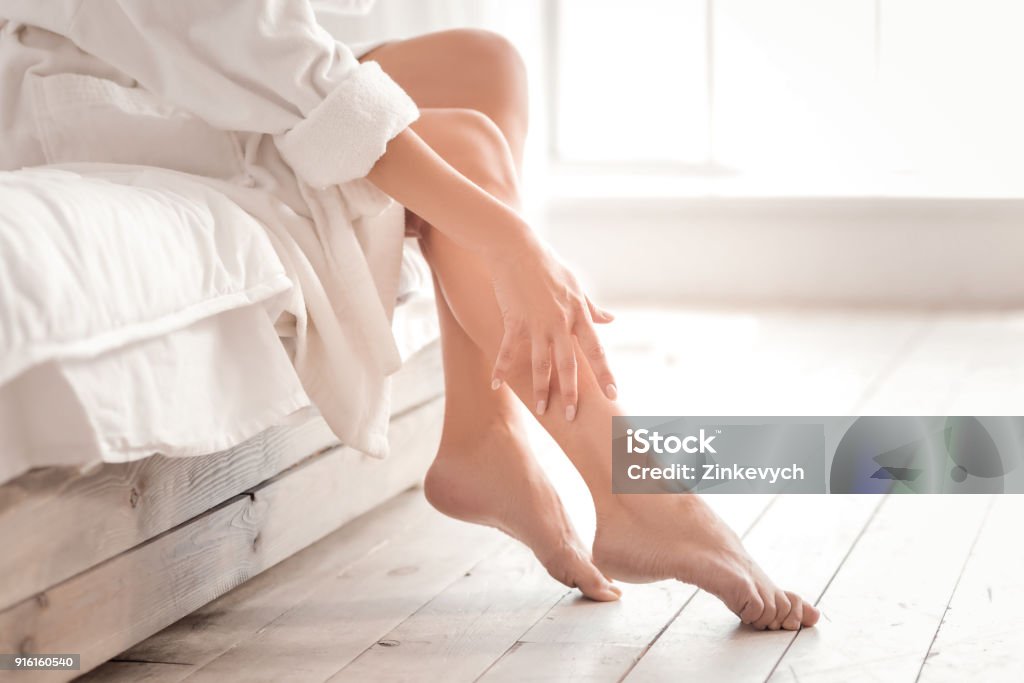 Close up of female legs So beautiful. Close up of beautiful female legs while being taking care of after shower Leg Stock Photo