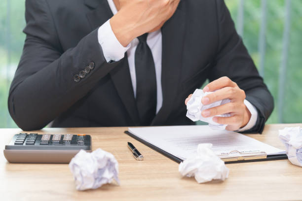 istock Stressed businessman crumple paper with calculator and contract document - making a mistake concept 916167284