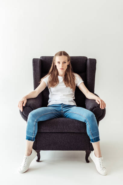 istock Girl sitting on armchair 916167478